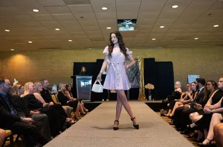 A model poses on the during the Little Black Dress Event Fashion Show